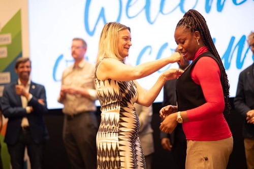 Receiving the IASP pin from IASP President Lena Miranda